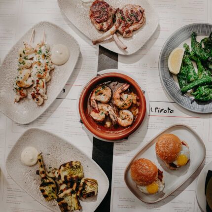 A table full of shared tapas small plates during an evening dinner.