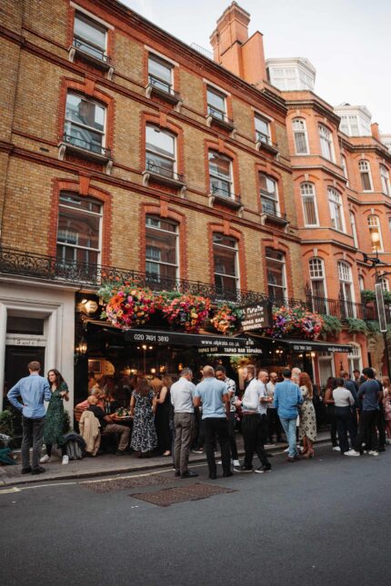 Mayfair premium Spanish wine tapas bar group crowd outside